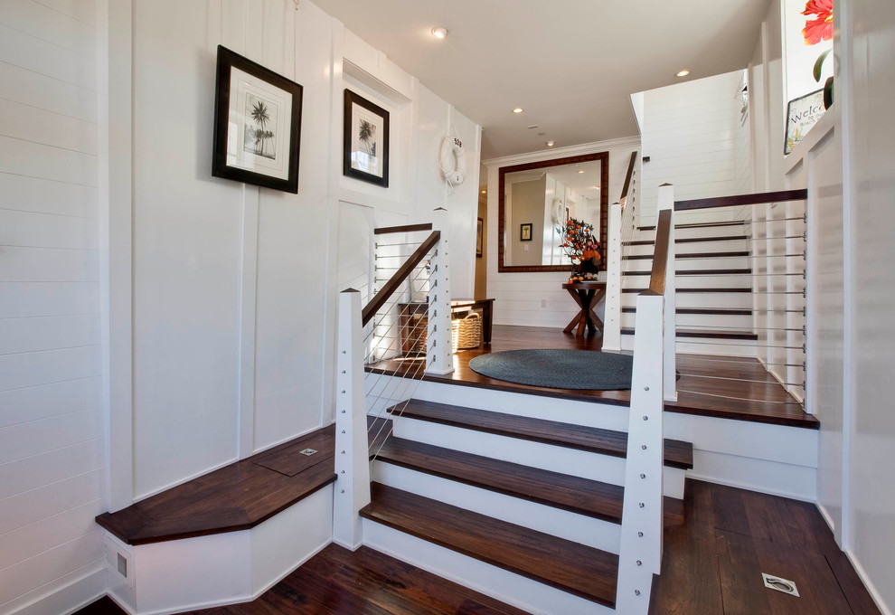 Inspiration for a traditional foyer in Los Angeles with white walls and dark hardwood floors.