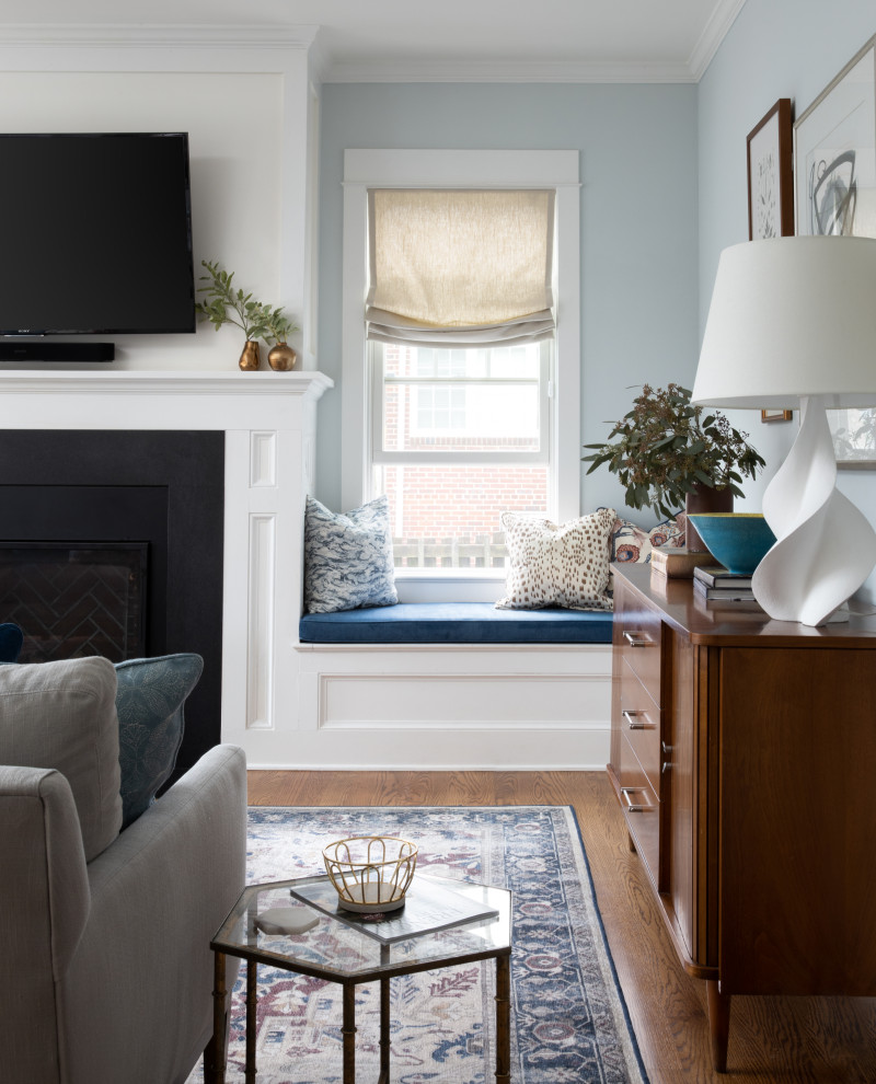 Aménagement d'une salle de séjour éclectique ouverte avec un mur bleu, un sol en bois brun, une cheminée standard, un téléviseur fixé au mur et un sol marron.
