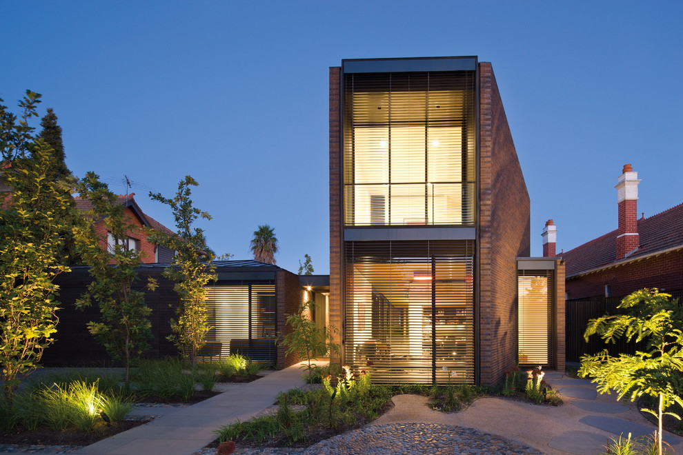 This is an example of a large modern two-storey brick brown exterior in Melbourne.
