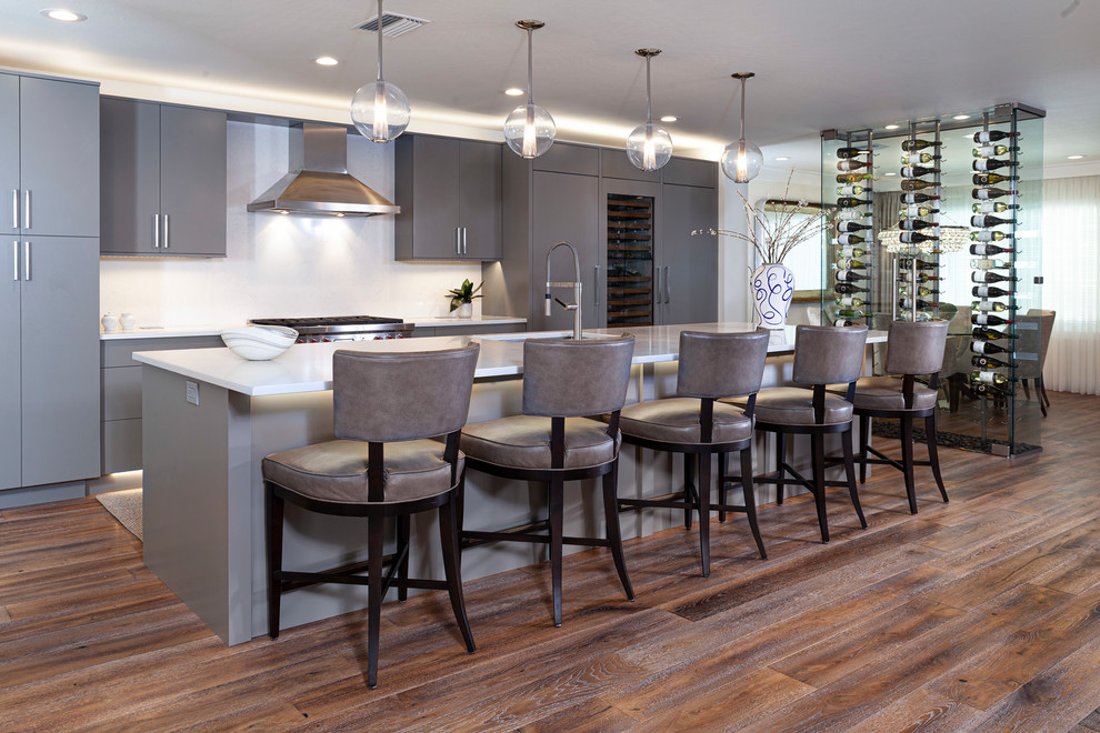 Inspiration for a contemporary galley kitchen in Tampa with an undermount sink, flat-panel cabinets, grey cabinets, dark hardwood floors, with island, brown floor and white benchtop.