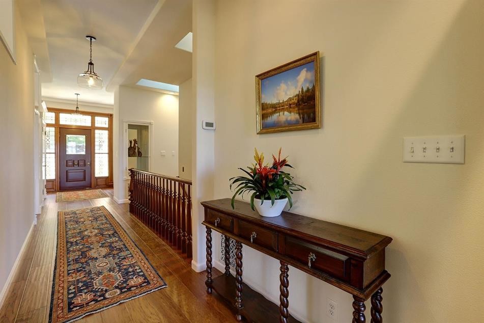 Mid-sized traditional hallway in Sacramento with beige walls, medium hardwood floors and brown floor.