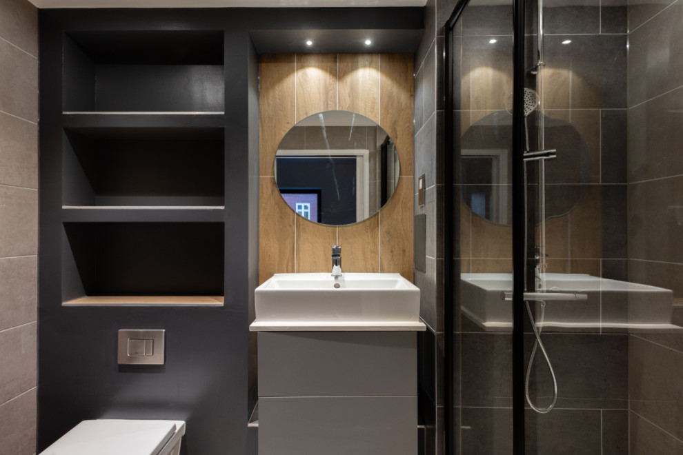 Doorless shower - mid-sized contemporary 3/4 gray tile single-sink doorless shower idea in London with a one-piece toilet, gray walls, a hinged shower door and white countertops