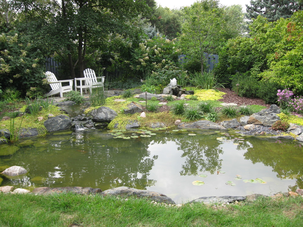 Inspiration for a large country garden in Omaha with a water feature.