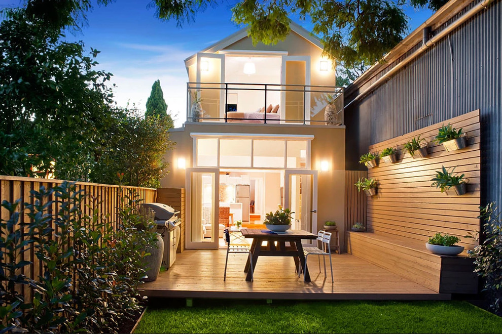 This is an example of a mid-sized contemporary backyard patio in Sydney with decking and no cover.