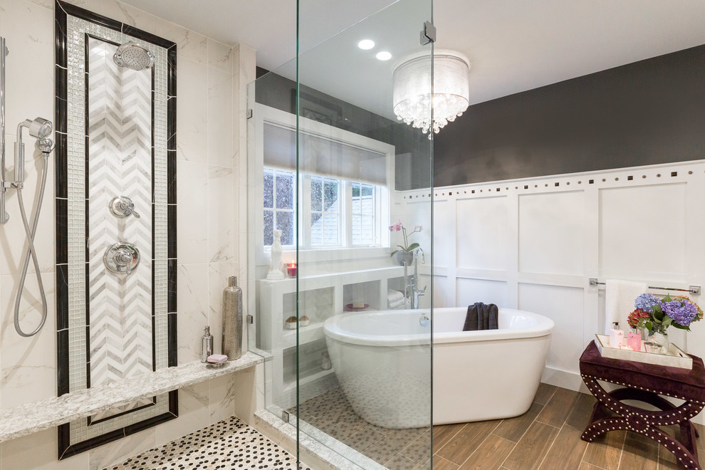 This is an example of a large transitional master bathroom in Manchester with shaker cabinets, white cabinets, a freestanding tub, an open shower, a one-piece toilet, white tile, porcelain tile, black walls, dark hardwood floors, a wall-mount sink and engineered quartz benchtops.