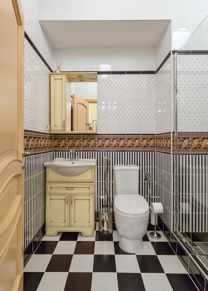 Inspiration for a traditional 3/4 bathroom in Moscow with black and white tile, multi-coloured tile, yellow cabinets and recessed-panel cabinets.
