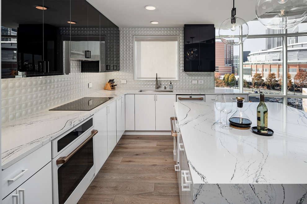 Eat-in kitchen - small contemporary l-shaped eat-in kitchen idea in Charlotte with an undermount sink, flat-panel cabinets, white appliances and an island
