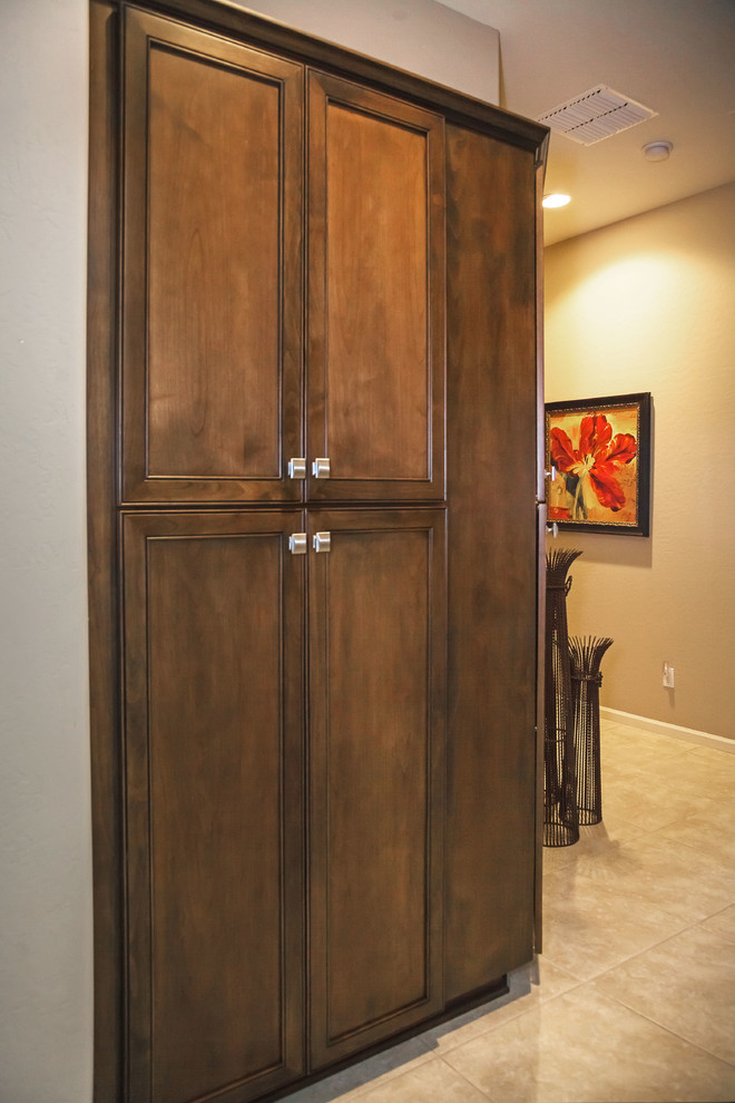 Eat-in kitchen - transitional ceramic tile eat-in kitchen idea in Phoenix with an undermount sink, recessed-panel cabinets, dark wood cabinets, quartzite countertops, gray backsplash, stone tile backsplash, stainless steel appliances and an island