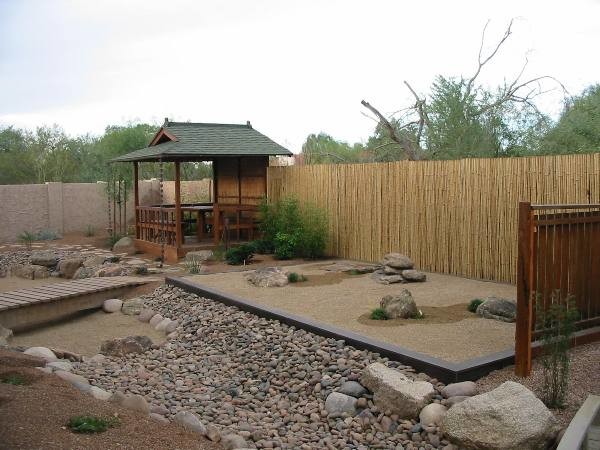 This is an example of an asian backyard garden in Phoenix with a garden path.