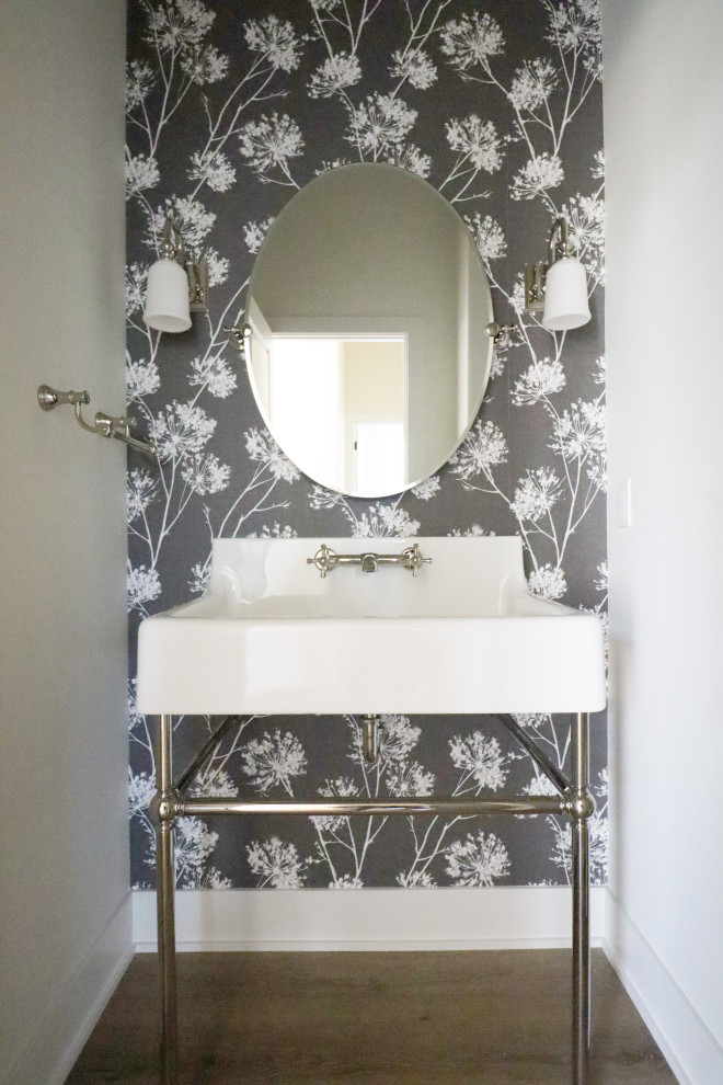 Photo of a traditional cloakroom in Omaha with a two-piece toilet, a console sink, a freestanding vanity unit and wallpapered walls.