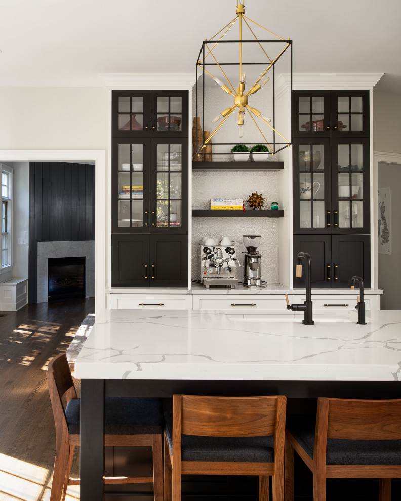 Inspiration for a large transitional medium tone wood floor eat-in kitchen remodel in New York with a farmhouse sink, shaker cabinets, quartz countertops, white backsplash, porcelain backsplash, paneled appliances, an island and white countertops