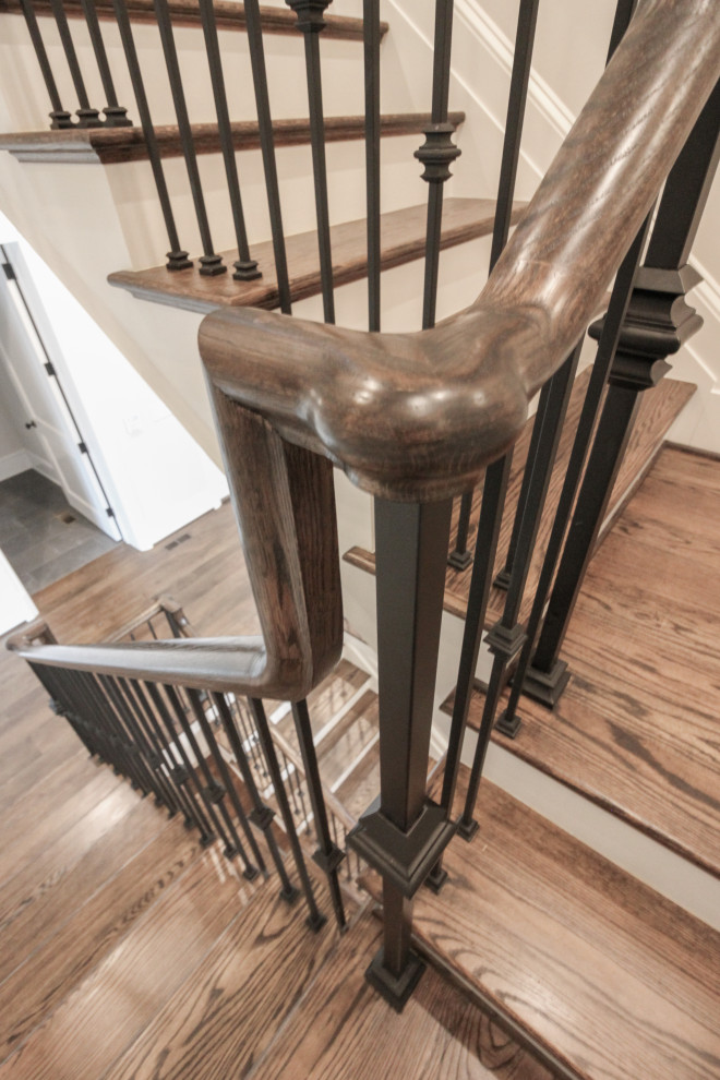 Design ideas for a large traditional wood floating staircase in DC Metro with painted wood risers and metal railing.