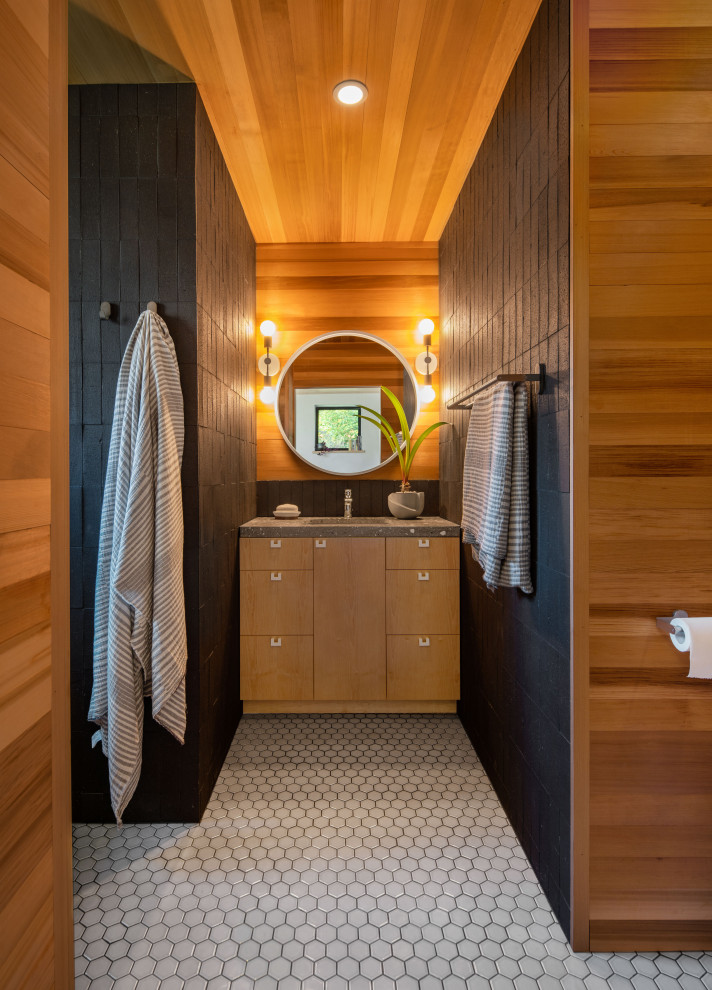 Mid-sized contemporary master bathroom in Boston with flat-panel cabinets, medium wood cabinets, an alcove tub, black tile, ceramic tile, black walls, ceramic floors, an undermount sink, white floor, grey benchtops, a single vanity, a built-in vanity, wood and wood walls.