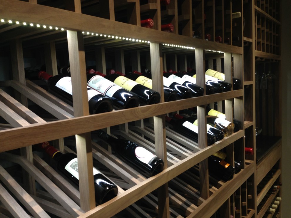 Mid-sized contemporary wine cellar in Los Angeles with light hardwood floors and display racks.