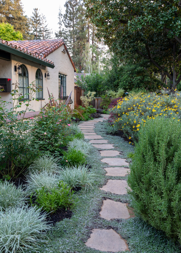 Inspiration for a mid-sized mediterranean side yard full sun xeriscape in San Francisco with a garden path and natural stone pavers.