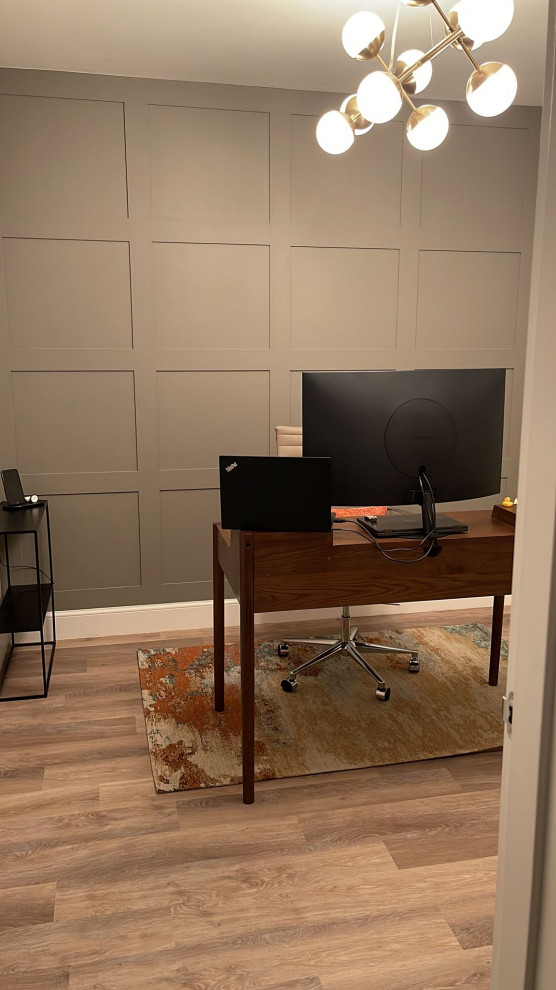 Ejemplo de despacho retro de tamaño medio con suelo vinílico y panelado