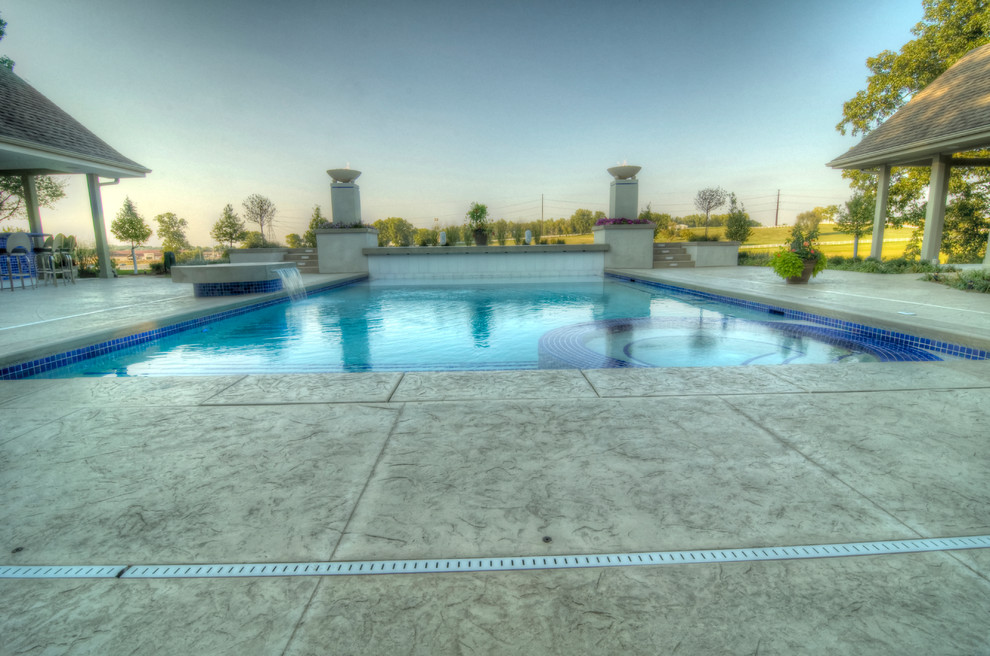Example of a large transitional backyard concrete paver and rectangular natural hot tub design in Cedar Rapids