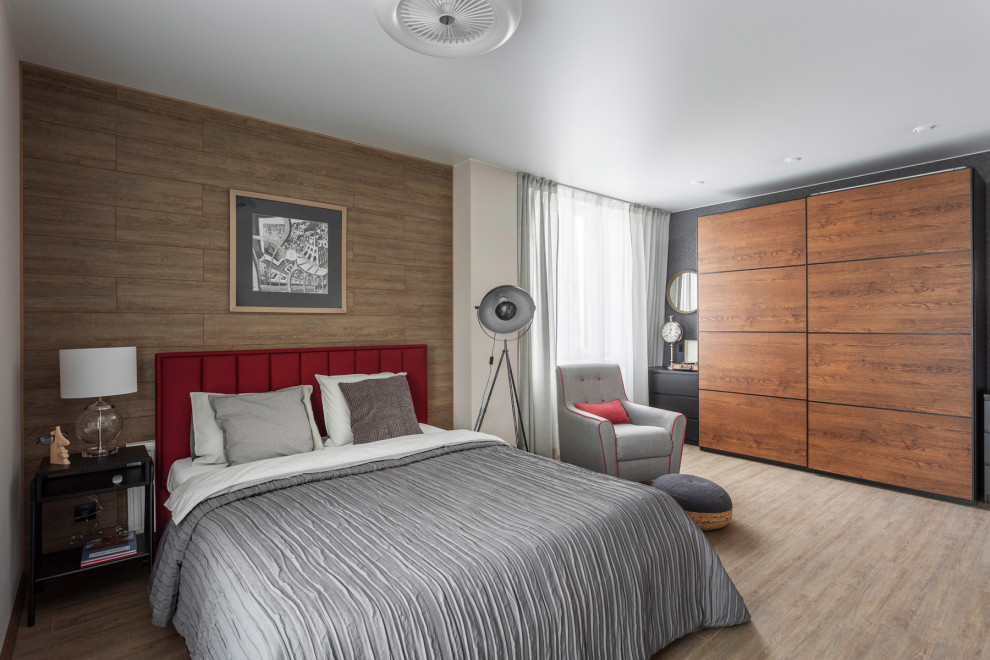 Inspiration for a large urban master bedroom in Yekaterinburg with beige walls, laminate floors, no fireplace, brown floors, wallpapered walls and a feature wall.
