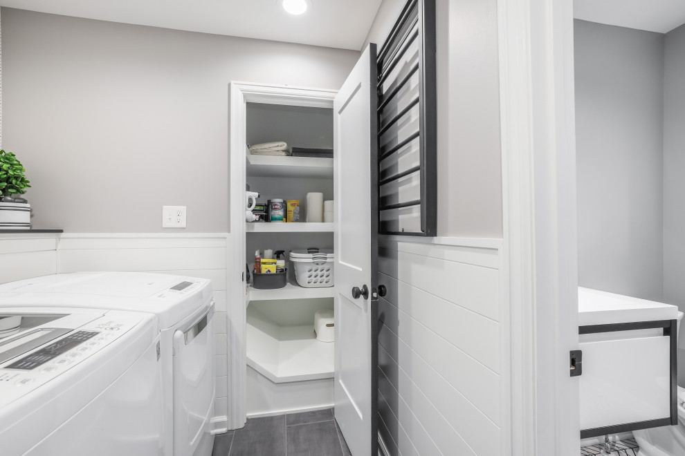 Small transitional single-wall dedicated laundry room in Columbus with shiplap splashback, grey walls, porcelain floors, a side-by-side washer and dryer, grey floor and wallpaper.