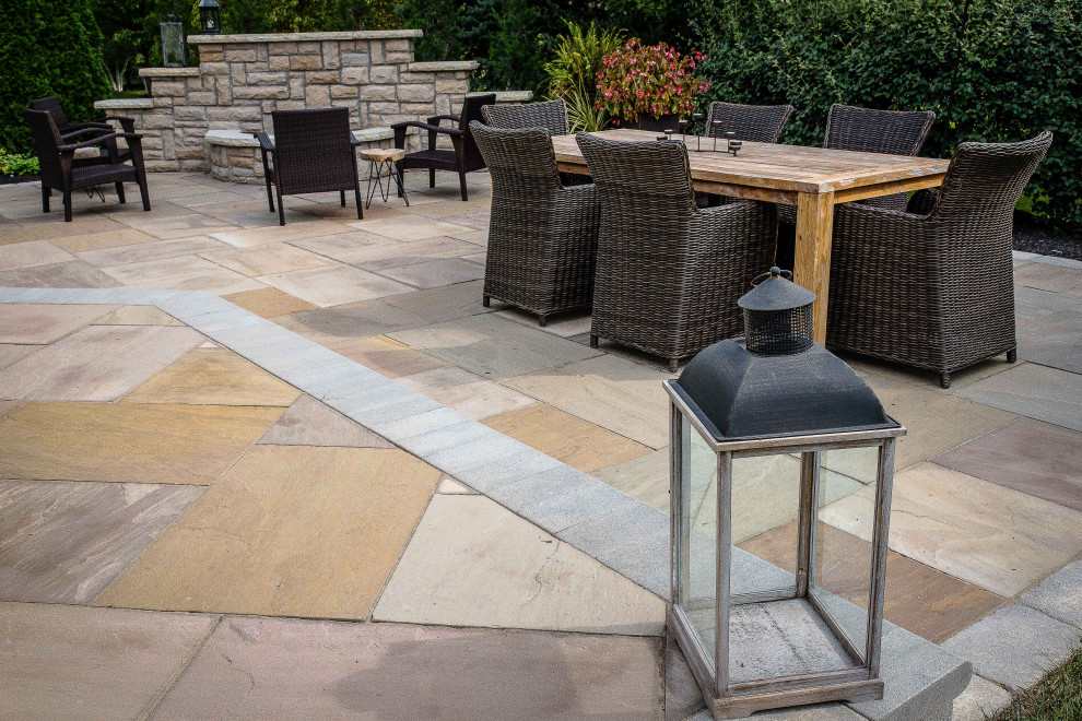Inspiration for a large classic back patio in Columbus with a fireplace and concrete paving.
