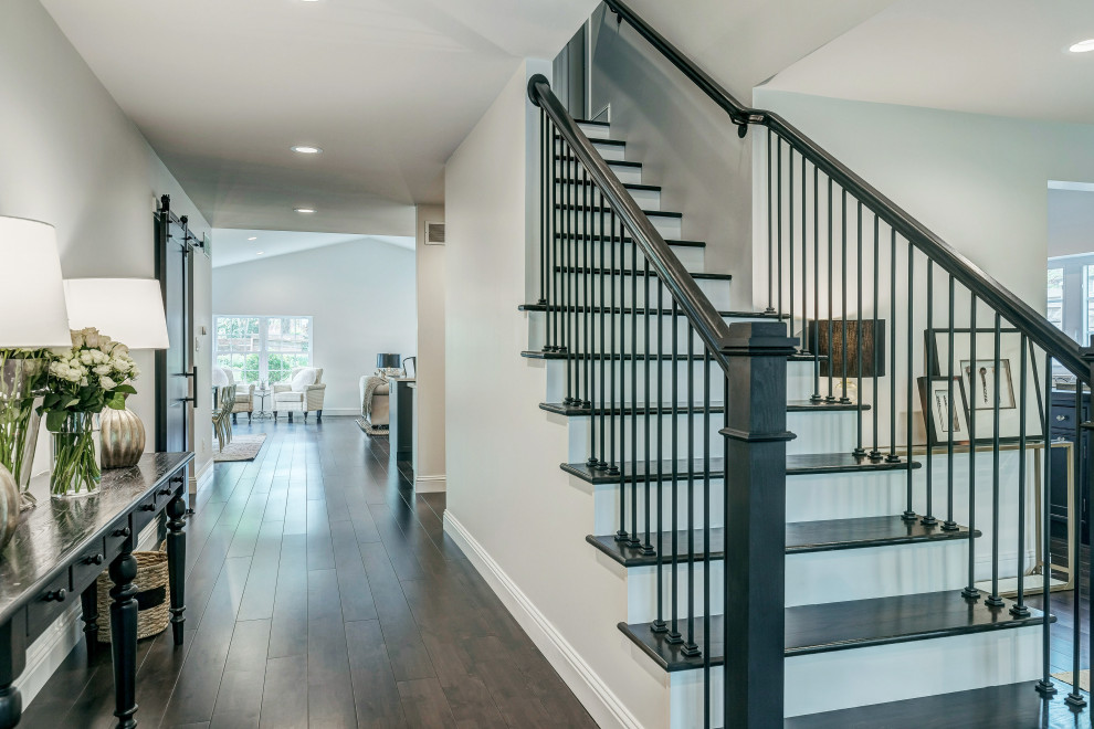This is an example of a large traditional wood straight staircase in St Louis with painted wood risers and mixed railing.