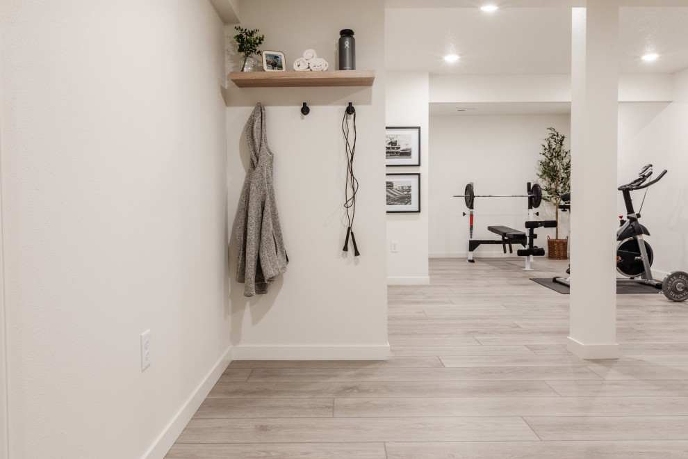 Design ideas for a mid-sized modern multipurpose gym in Cedar Rapids with white walls, vinyl floors, grey floor and vaulted.