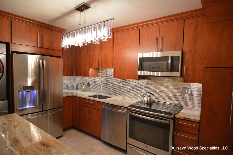Example of a small transitional l-shaped terra-cotta tile enclosed kitchen design in DC Metro with an undermount sink, flat-panel cabinets, medium tone wood cabinets, quartzite countertops, gray backsplash, metal backsplash and stainless steel appliances