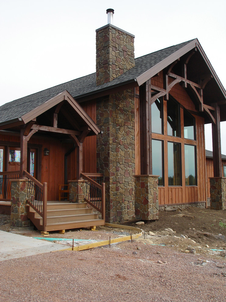 Example of a large mountain style brown one-story wood exterior home design in Charlotte