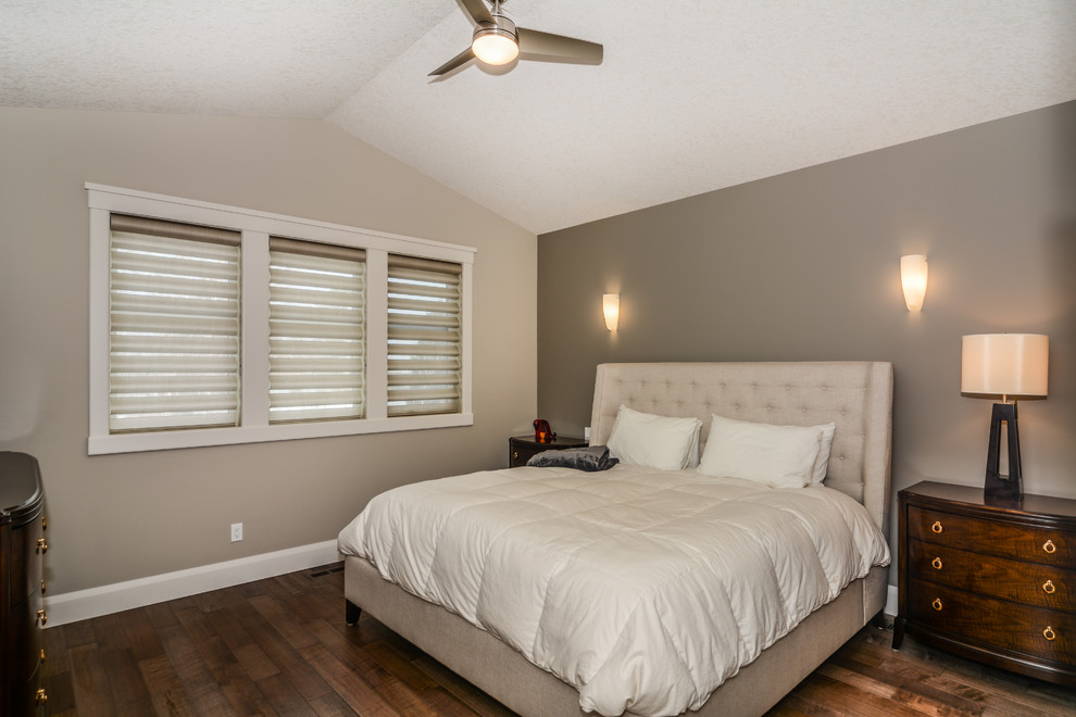 Photo of a large transitional master bedroom in Calgary with grey walls, no fireplace and dark hardwood floors.