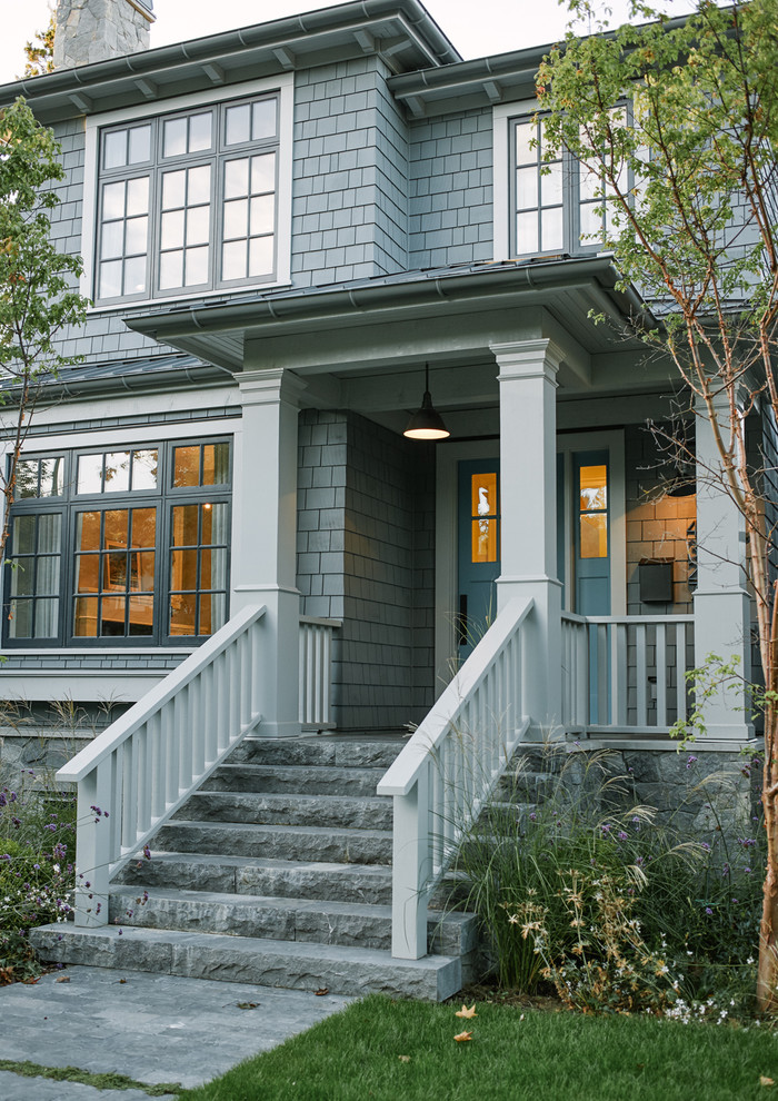 Photo of a mid-sized traditional three-storey blue exterior in Vancouver with wood siding.