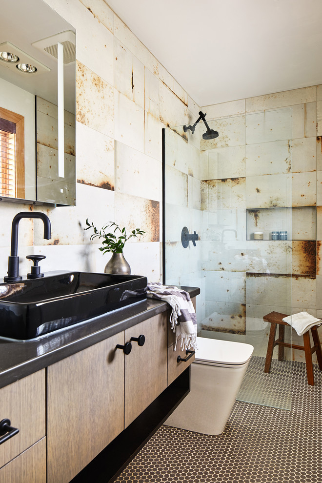 Inspiration for a mid-sized industrial bathroom in DC Metro with grey benchtops, flat-panel cabinets, light wood cabinets, an alcove shower, beige tile, mosaic tile floors, a vessel sink, brown floor and an open shower.