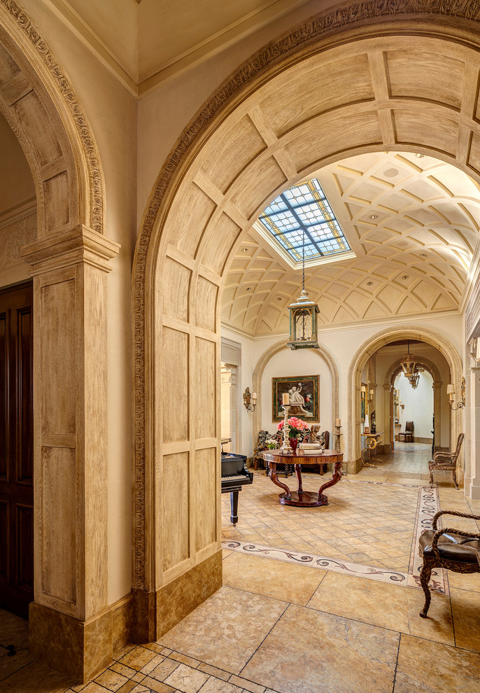 Inspiration for an expansive mediterranean foyer in Other with beige walls, travertine floors and brown floor.