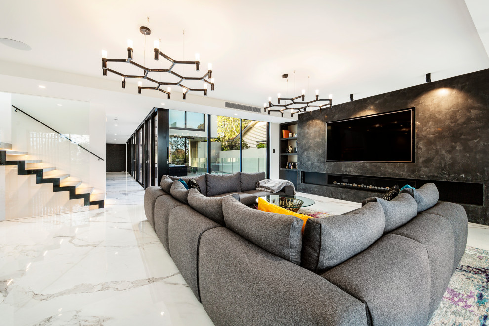 Inspiration for a large contemporary formal open concept living room in Melbourne with black walls, marble floors, a ribbon fireplace, a metal fireplace surround, a built-in media wall and white floor.