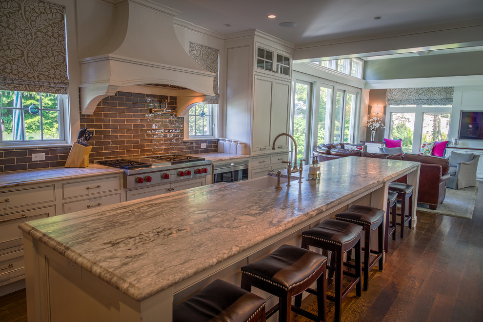 Eat-in kitchen - mid-sized transitional galley dark wood floor eat-in kitchen idea in Bridgeport with a farmhouse sink, recessed-panel cabinets, gray cabinets, granite countertops, gray backsplash, subway tile backsplash, stainless steel appliances and two islands