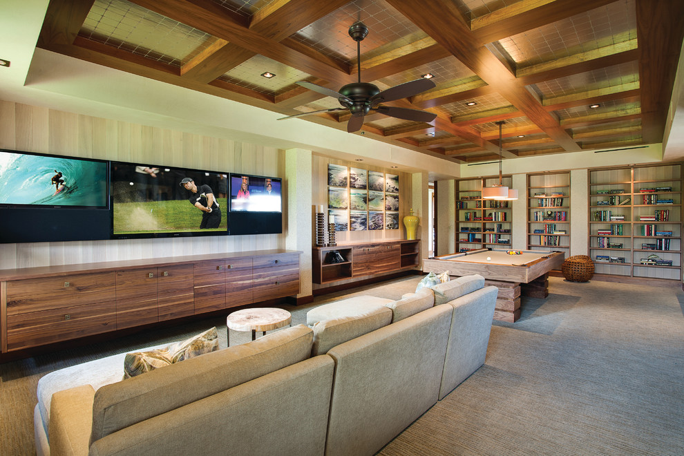 Photo of a tropical open concept family room in Vancouver with beige walls, carpet and a wall-mounted tv.
