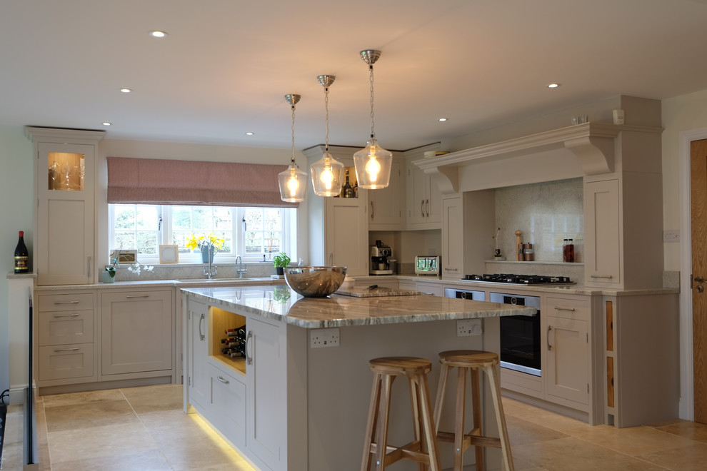 Photo of a large contemporary l-shaped open plan kitchen in Hampshire with an undermount sink, shaker cabinets, grey cabinets, granite benchtops, multi-coloured splashback, stone slab splashback, stainless steel appliances, limestone floors, with island, multi-coloured floor and multi-coloured benchtop.