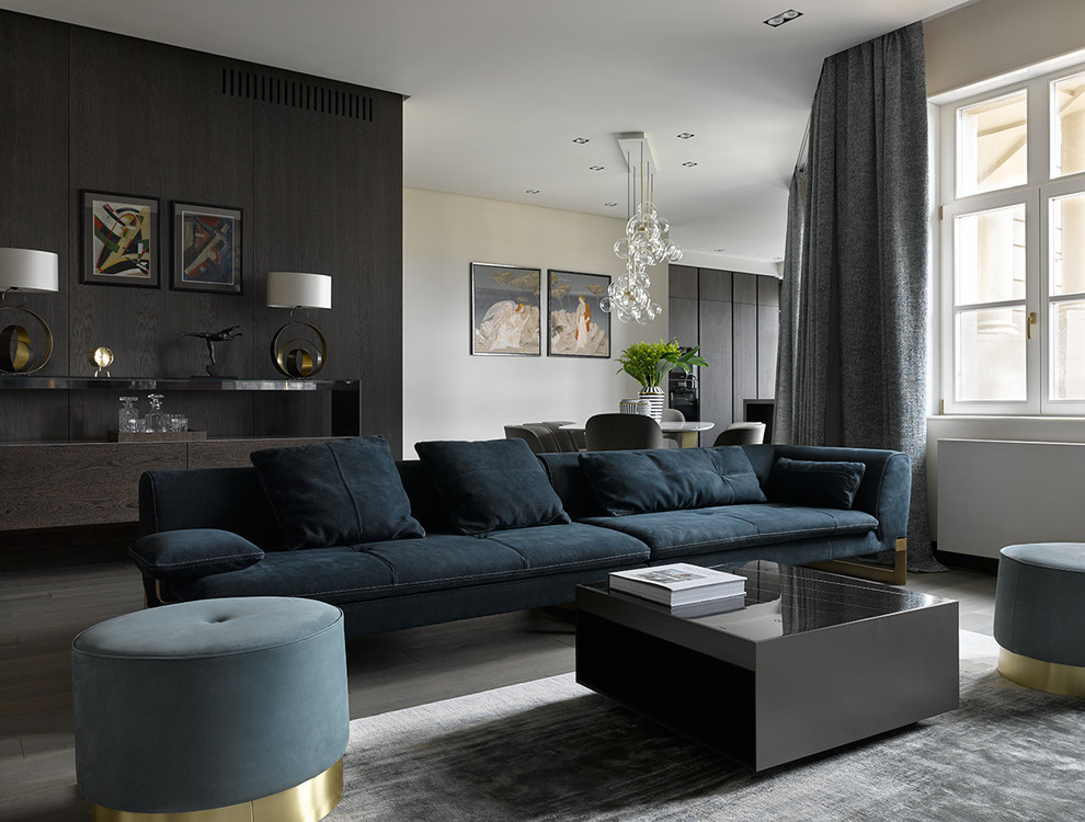 This is an example of a contemporary formal living room in Moscow with white walls and dark hardwood floors.