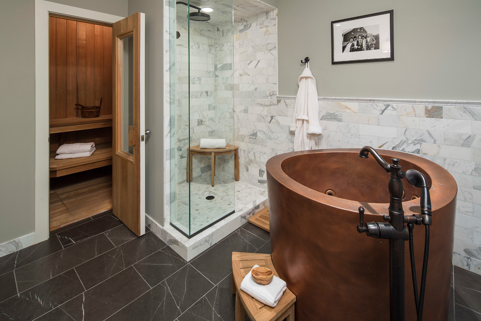 Design ideas for a large traditional master bathroom in Minneapolis with flat-panel cabinets, marble floors, light wood cabinets, a japanese tub, an open shower, black and white tile, stone slab, grey walls, marble benchtops, a one-piece toilet and an integrated sink.