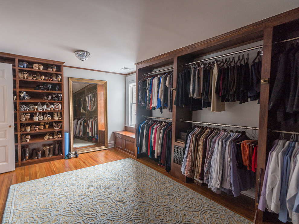 Design ideas for a traditional storage and wardrobe in New York with dark wood cabinets and medium hardwood floors.