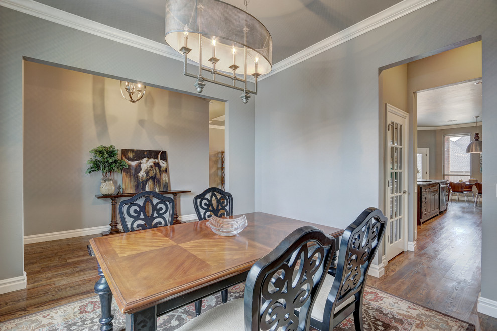 Mid-sized transitional separate dining room in Oklahoma City with grey walls and medium hardwood floors.