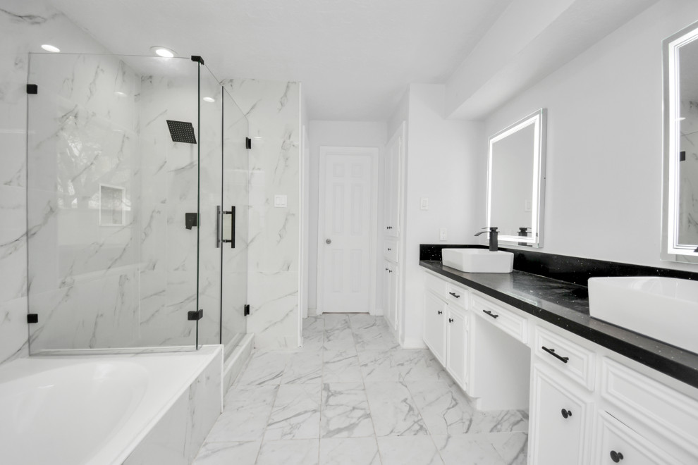 Inspiration for a mid-sized modern master bathroom in Houston with beaded inset cabinets, white cabinets, a hot tub, a corner shower, gray tile, porcelain tile, grey walls, porcelain floors, a vessel sink, engineered quartz benchtops, multi-coloured floor, a hinged shower door, black benchtops, a double vanity and a floating vanity.