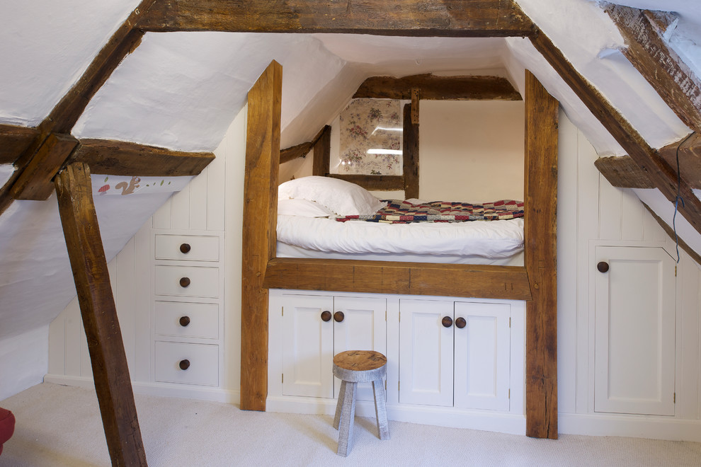 Photo of a country gender-neutral kids' bedroom in Sussex with white walls and carpet.