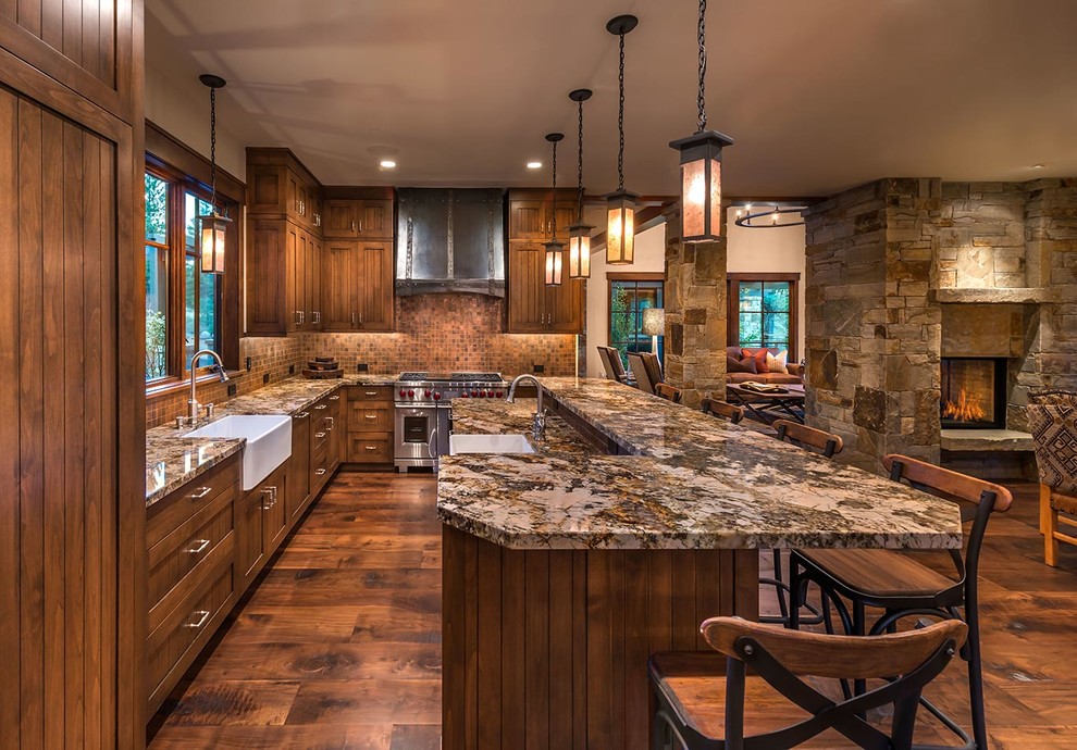 Inspiration for a country l-shaped open plan kitchen in Sacramento with a farmhouse sink, shaker cabinets, dark wood cabinets, brown splashback, mosaic tile splashback, stainless steel appliances, dark hardwood floors and with island.