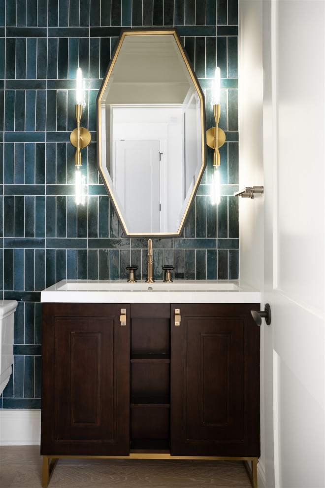 Mid-sized beach style powder room in Indianapolis with shaker cabinets, brown cabinets, a one-piece toilet, medium hardwood floors, an undermount sink and a built-in vanity.