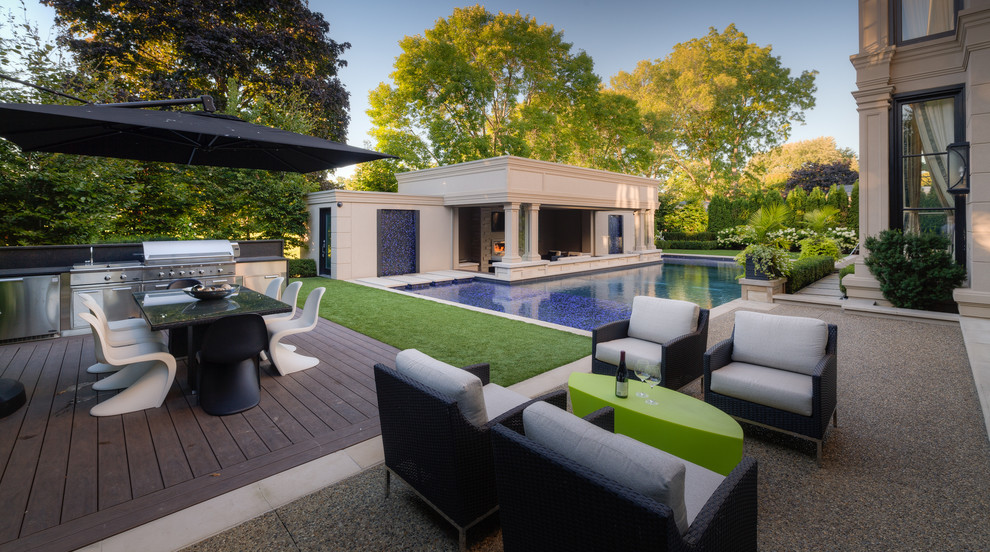 Design ideas for an expansive modern backyard custom-shaped pool in Toronto with a pool house.