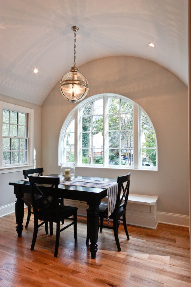 This is an example of a traditional dining room in Newark with beige walls and dark hardwood floors.