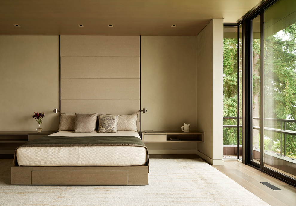 This is an example of a contemporary bedroom in Seattle with beige walls, light hardwood floors and beige floor.
