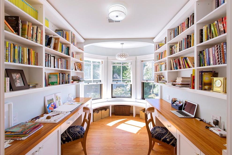 Inspiration for a traditional home office in Boston with grey walls and medium hardwood floors.