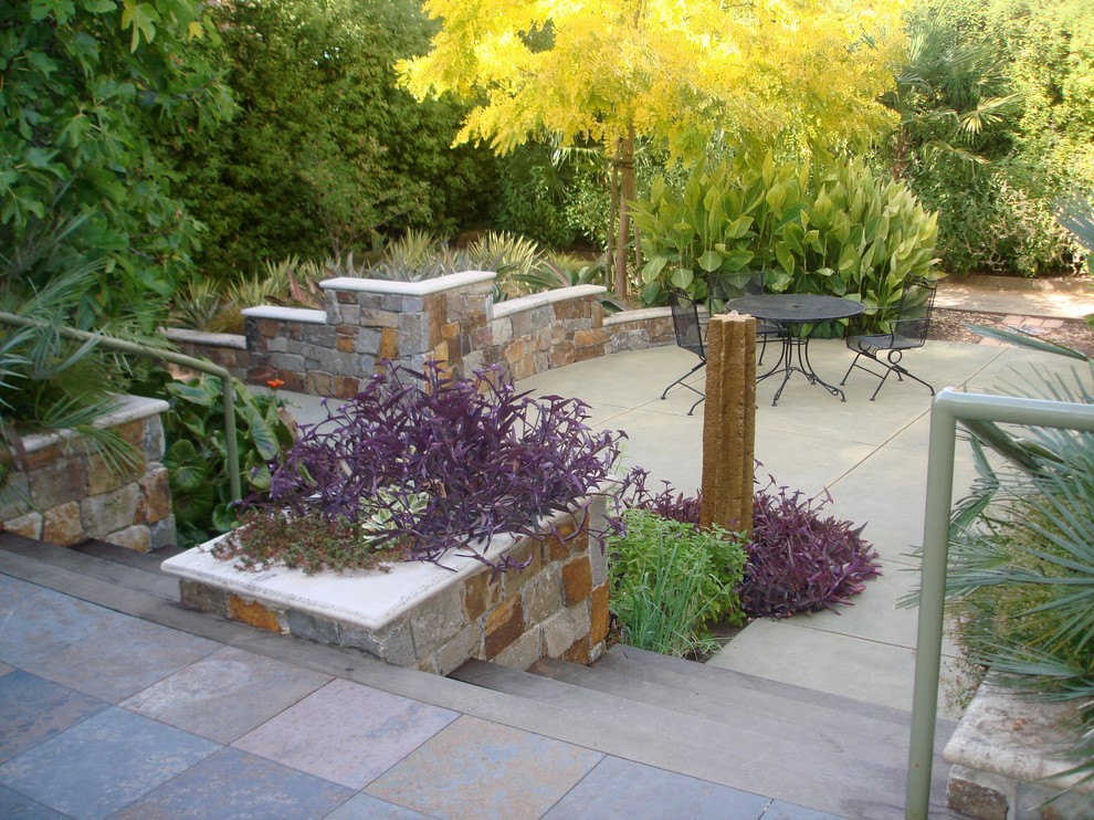 Photo of an expansive contemporary backyard patio in San Francisco with a water feature, concrete slab and no cover.