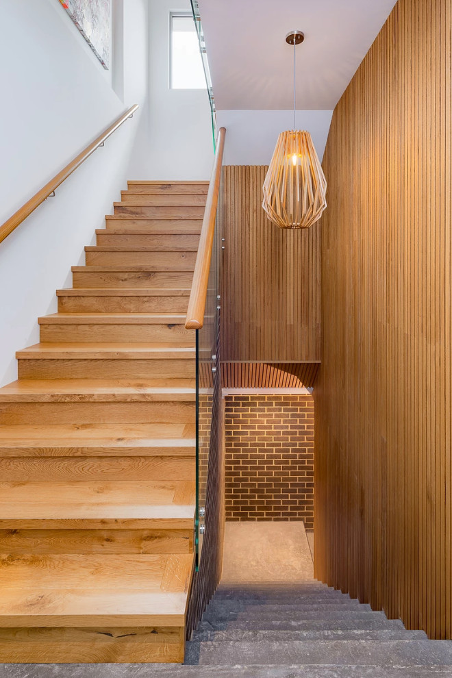 Photo of a mid-sized contemporary wood u-shaped staircase in Perth with wood risers and mixed railing.